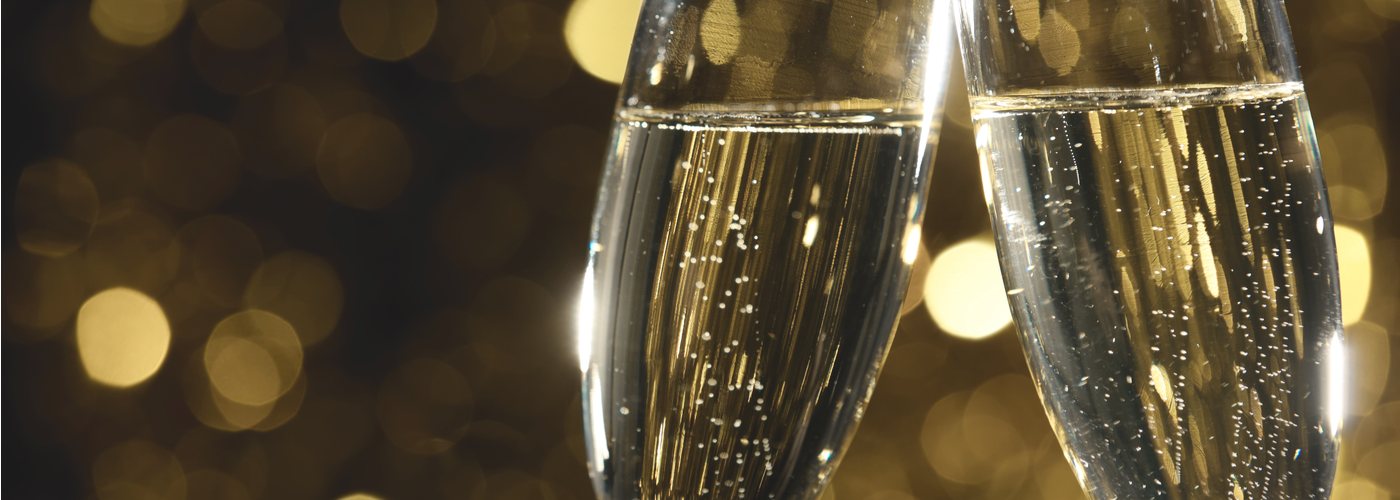 Flutes of champagne in holiday setting,Closeup. via Shutterstock