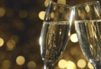 Flutes of champagne in holiday setting,Closeup. via Shutterstock