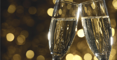 Flutes of champagne in holiday setting,Closeup. via Shutterstock